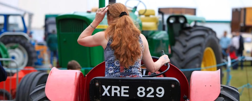 Woman driving a tractor at The New Forest Show.